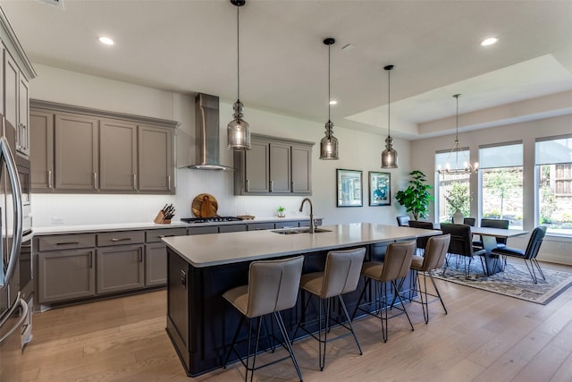 2313 Sandlin Dr, Fort Worth, TX 76008 - kitchen featuring wall chimney exhaust hood, a sink, gray cabinetry, decorative backsplash, and gas cooktop