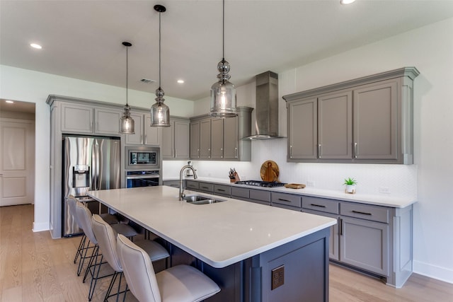 2313 Sandlin Dr, Fort Worth, TX 76008 - kitchen with wall chimney exhaust hood, gray cabinets, appliances with stainless steel finishes, a sink, and light wood finished floors