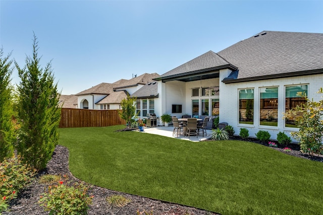 2313 Sandlin Dr, Fort Worth, TX 76008 - rear view of house with roof with shingles, a patio area, brick siding, a yard, and fence