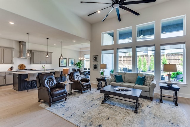 2313 Sandlin Dr, Fort Worth, TX 76008 - living area featuring a high ceiling, light wood finished floors, a notable chandelier, and recessed lighting