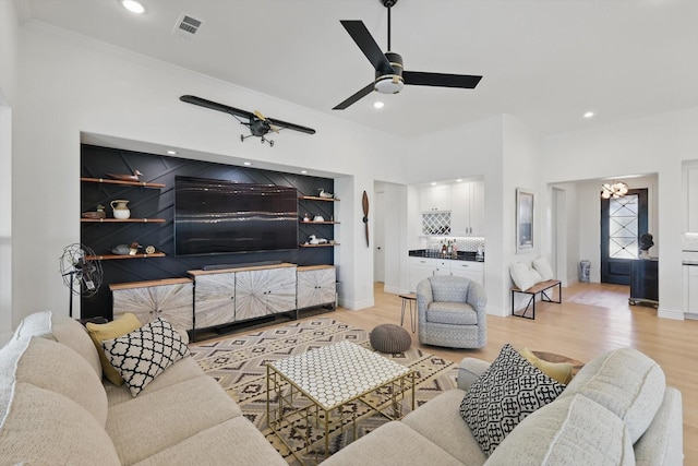 12424 Blue Granite Dr, Denton, TX 76207 - living room featuring light wood-style floors, baseboards, recessed lighting, a ceiling fan, and a chandelier