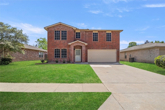 traditional home featuring concrete driveway, an attached garage, a front yard, brick siding, and central AC unit