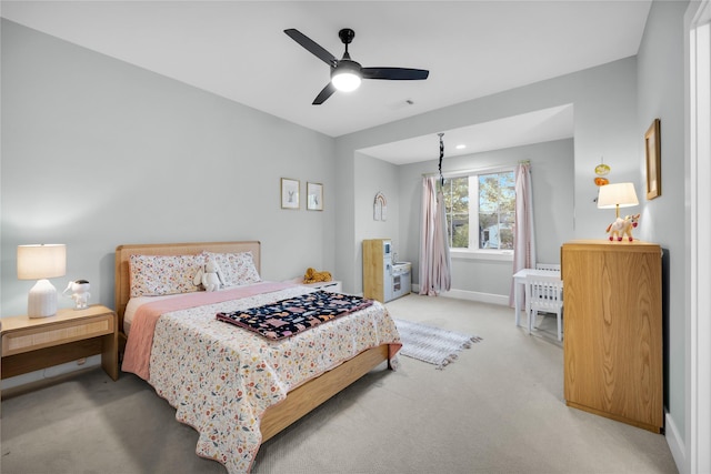 bedroom with light colored carpet, baseboards, a ceiling fan, and visible vents
