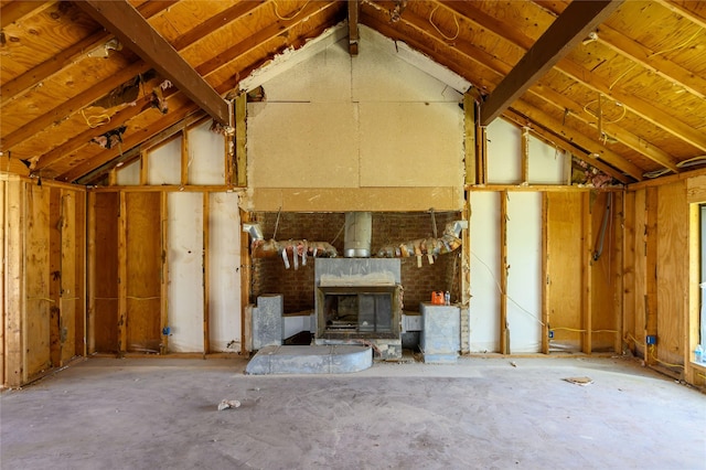unfurnished living room with a fireplace and vaulted ceiling