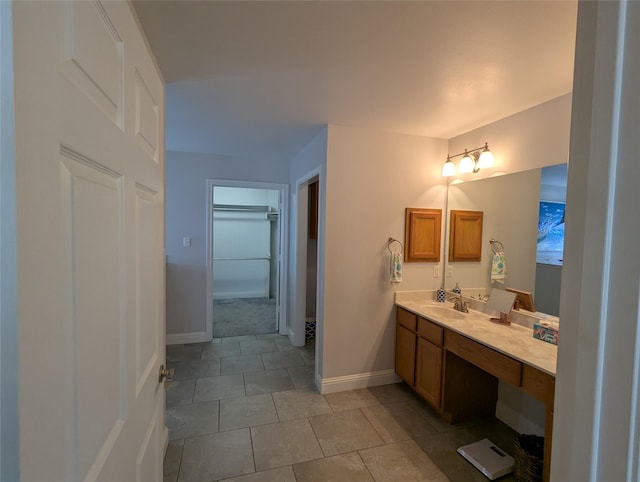 bathroom with tile patterned floors, vanity, and baseboards