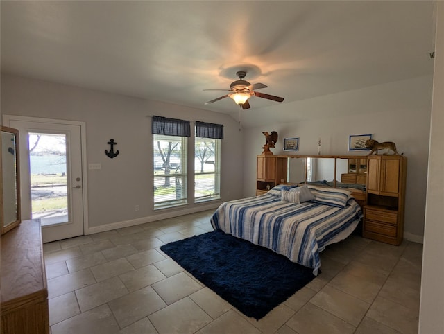 bedroom with light tile patterned floors, baseboards, multiple windows, and a ceiling fan