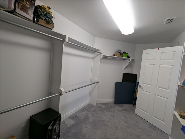 spacious closet with carpet flooring and visible vents