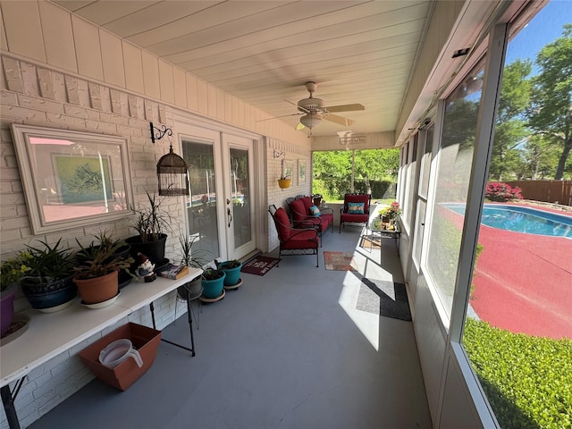 sunroom / solarium featuring a ceiling fan and plenty of natural light