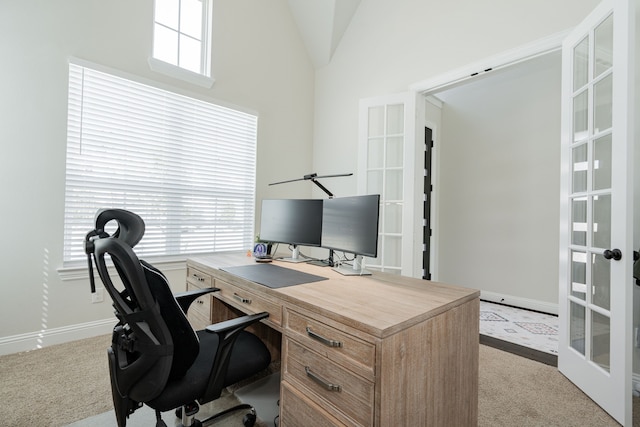 carpeted home office featuring french doors, baseboards, and vaulted ceiling