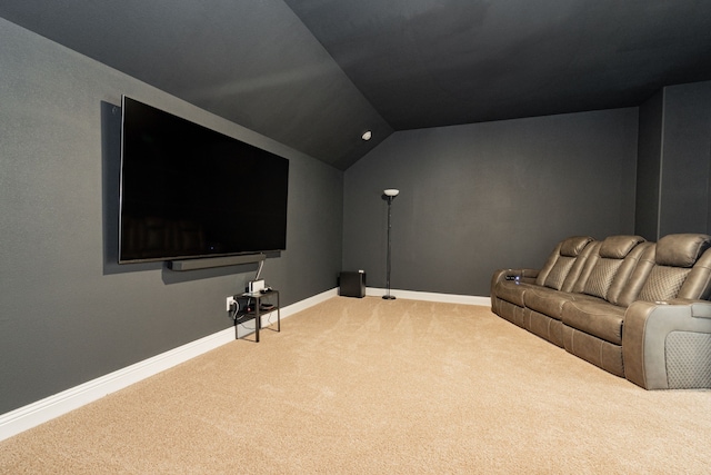 home theater room with carpet floors, baseboards, and lofted ceiling