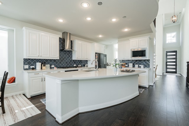 kitchen with stainless steel microwave, white cabinets, wall chimney exhaust hood, smart refrigerator, and a sink