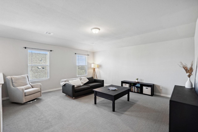 living room featuring baseboards, carpet flooring, and visible vents