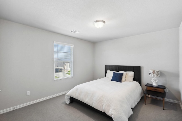 carpeted bedroom featuring baseboards and visible vents