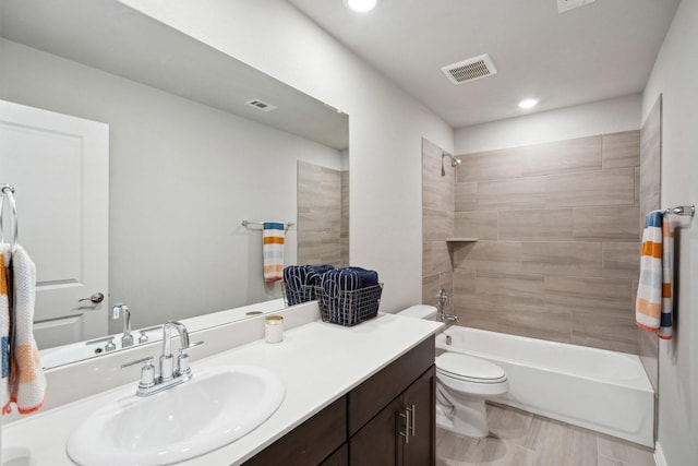 bathroom featuring toilet, vanity, visible vents, and recessed lighting
