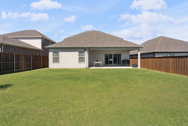 back of house featuring a fenced backyard, a patio, and a lawn
