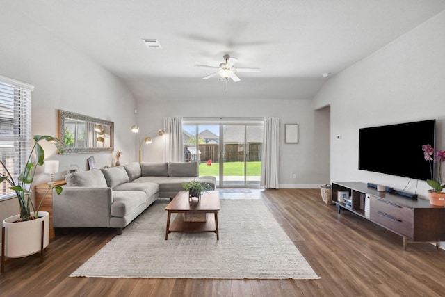 living area with wood finished floors, ceiling fan, baseboards, lofted ceiling, and visible vents