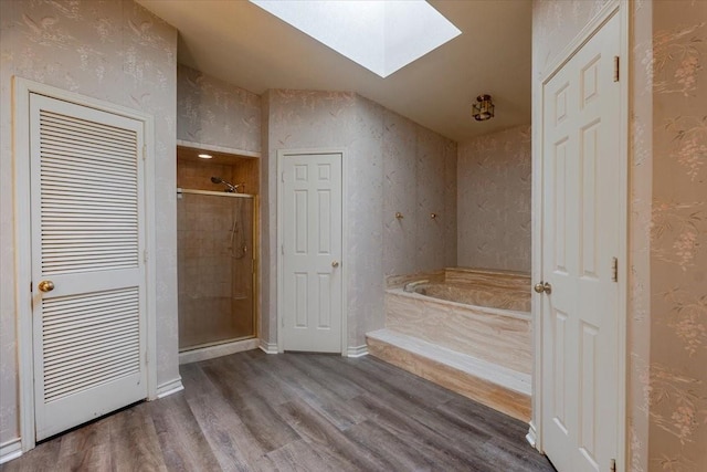 275 Salesville Rd, Mineral Wells, TX 76067 - full bath with a bath, baseboards, a skylight, wood finished floors, and a shower stall
