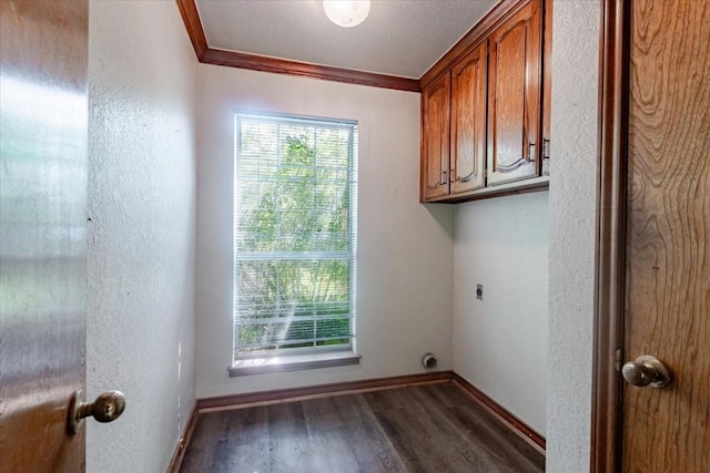 275 Salesville Rd, Mineral Wells, TX 76067 - laundry area featuring hookup for an electric dryer, dark wood-style flooring, crown molding, baseboards, and cabinet space