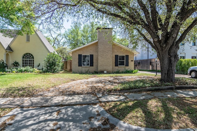 4077 Amherst Ave, University Park, TX 75225 - view of front of house with brick siding and a chimney