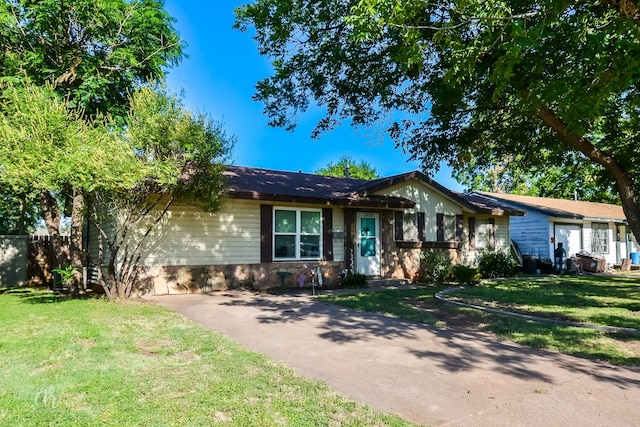 ranch-style house with a front lawn and stone siding