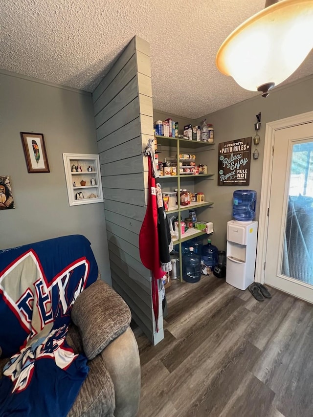 interior space featuring a textured ceiling and wood finished floors
