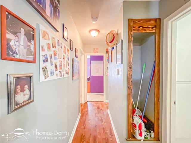 hall with light wood finished floors and baseboards