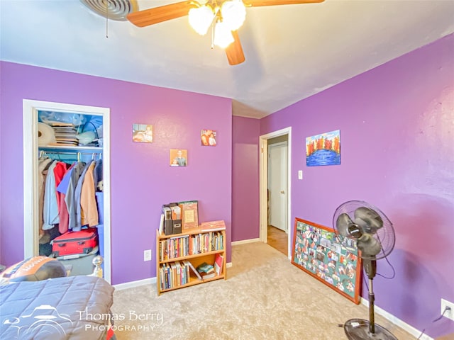 carpeted bedroom with ceiling fan, a closet, and baseboards