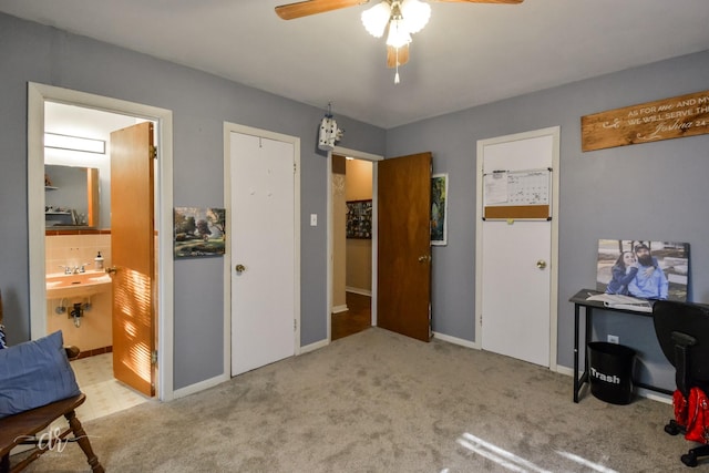 bedroom with ensuite bathroom, a ceiling fan, carpet flooring, and baseboards