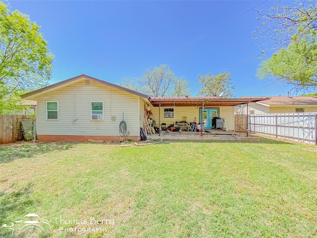 rear view of house with a yard, a patio area, and a fenced backyard