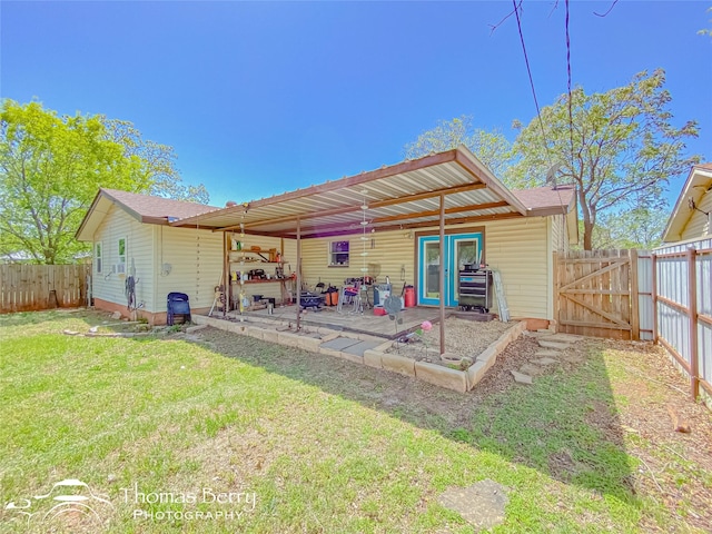 back of property featuring a lawn, a gate, a patio area, and a fenced backyard