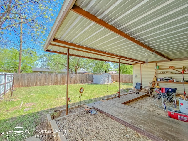 view of yard featuring an outbuilding, a shed, and a fenced backyard