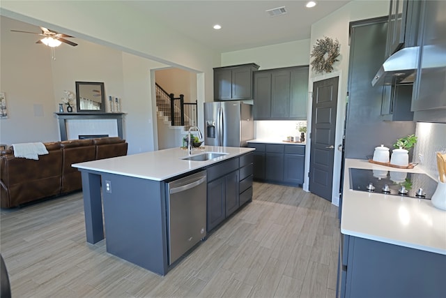 645 Summer Grove Dr, Midlothian, TX 76065 - kitchen featuring appliances with stainless steel finishes, a sink, open floor plan, light countertops, and a fireplace