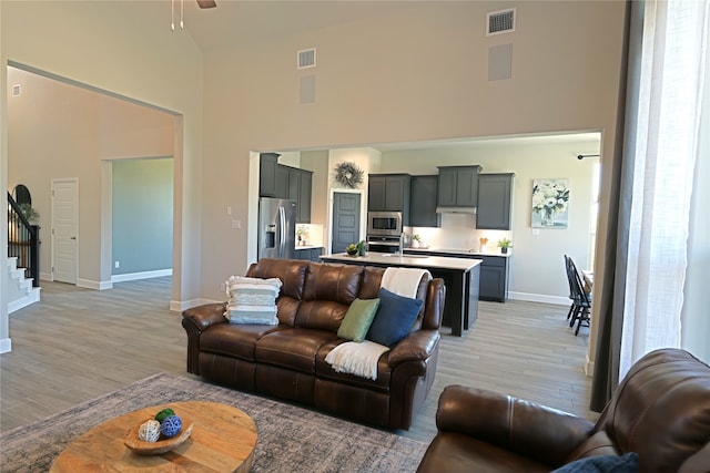 645 Summer Grove Dr, Midlothian, TX 76065 - living area with high vaulted ceiling, light wood-style floors, baseboards, stairway, and a ceiling fan