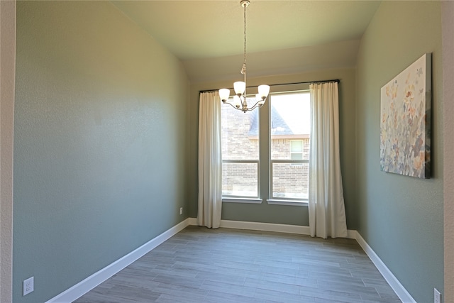 645 Summer Grove Dr, Midlothian, TX 76065 - spare room featuring a chandelier, wood finished floors, and baseboards