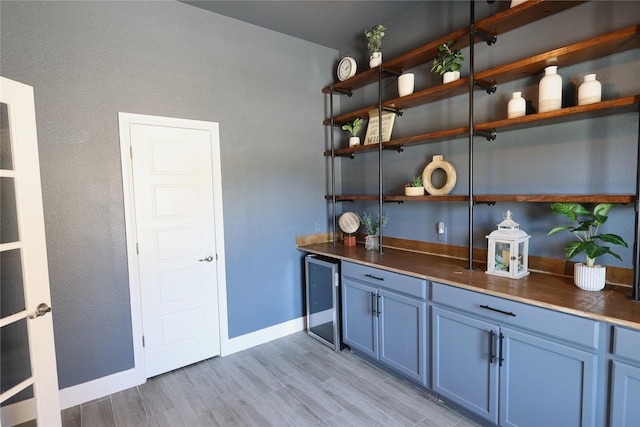 645 Summer Grove Dr, Midlothian, TX 76065 - indoor dry bar featuring beverage cooler, light wood-style flooring, and baseboards