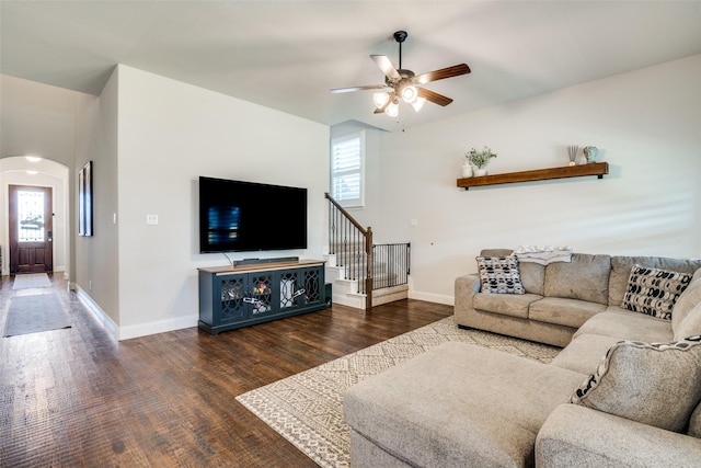 living area with a wealth of natural light, arched walkways, a ceiling fan, and wood finished floors
