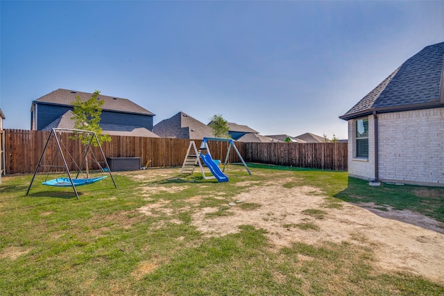 view of yard with a fenced backyard and a playground