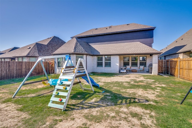 back of house with a patio, a fenced backyard, a playground, and a lawn