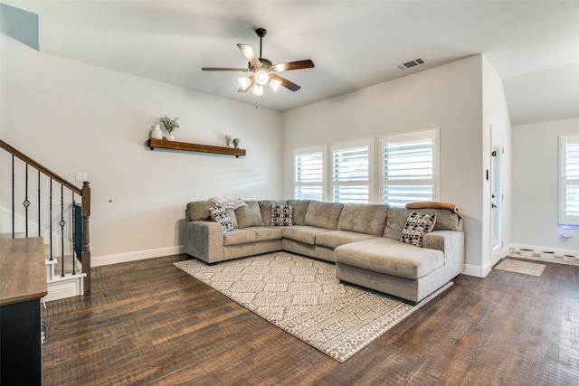 living room with a healthy amount of sunlight, stairway, visible vents, and ceiling fan