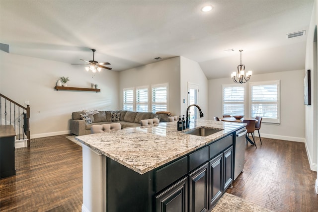 kitchen with baseboards, dishwasher, a sink, and visible vents