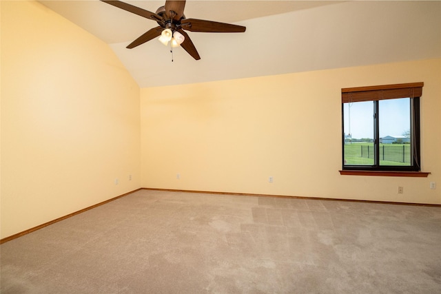 unfurnished room with baseboards, a ceiling fan, light colored carpet, and lofted ceiling