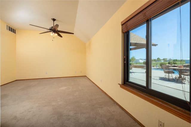 empty room featuring visible vents, light carpet, a ceiling fan, and lofted ceiling
