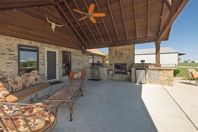 view of patio featuring area for grilling, ceiling fan, and fence