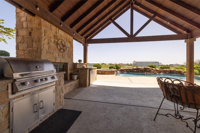 view of patio featuring a grill, an outdoor kitchen, a gazebo, and a pool with connected hot tub
