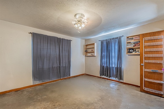 1206 John Reagan St, Benbrook, TX 76126 - empty room with baseboards, finished concrete flooring, ceiling fan, and a textured ceiling