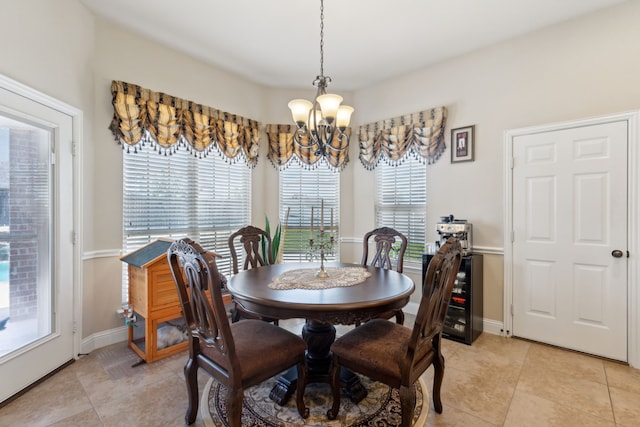 dining area featuring baseboards, an inviting chandelier, and light tile patterned flooring