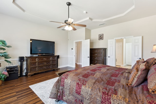 bedroom with visible vents, a high ceiling, a ceiling fan, and wood finished floors
