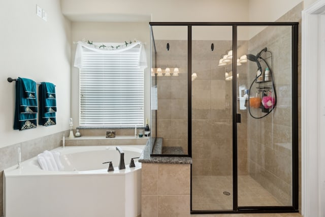 bathroom featuring visible vents, a stall shower, and a garden tub
