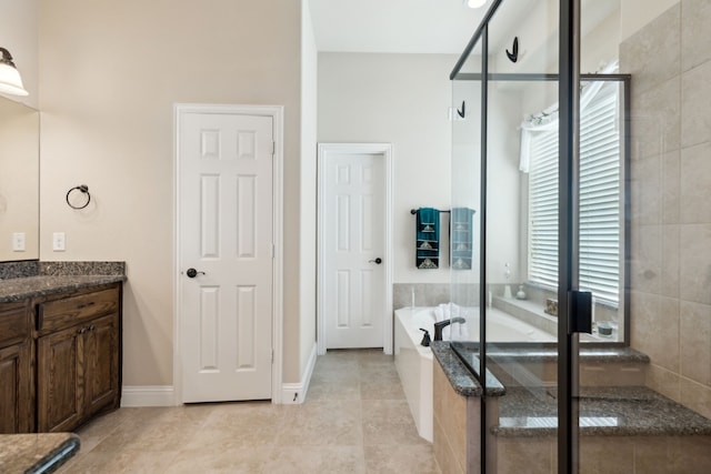 bathroom with vanity, baseboards, tile patterned floors, a bath, and a shower with shower door