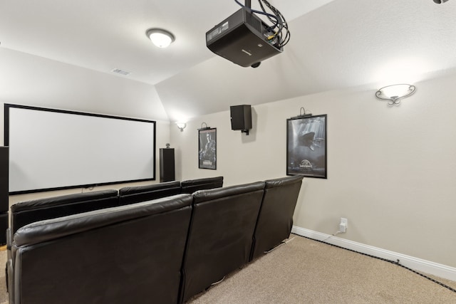 cinema room with light carpet, visible vents, baseboards, and lofted ceiling